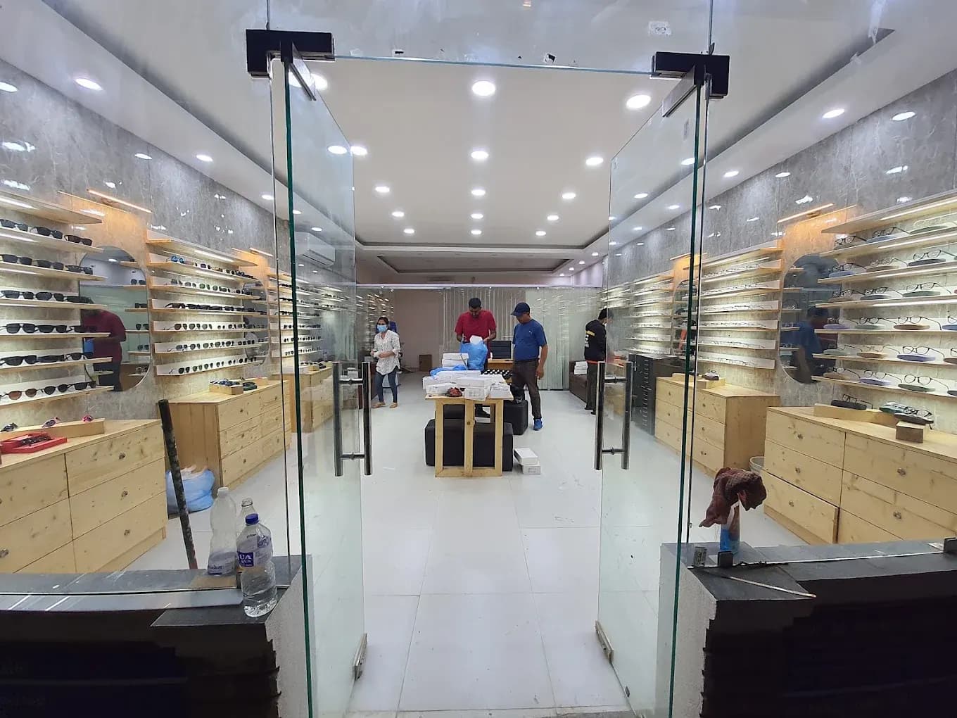 The Sight Savers shop front, looking in through the glass doors to the optical showroom with frames on both walls